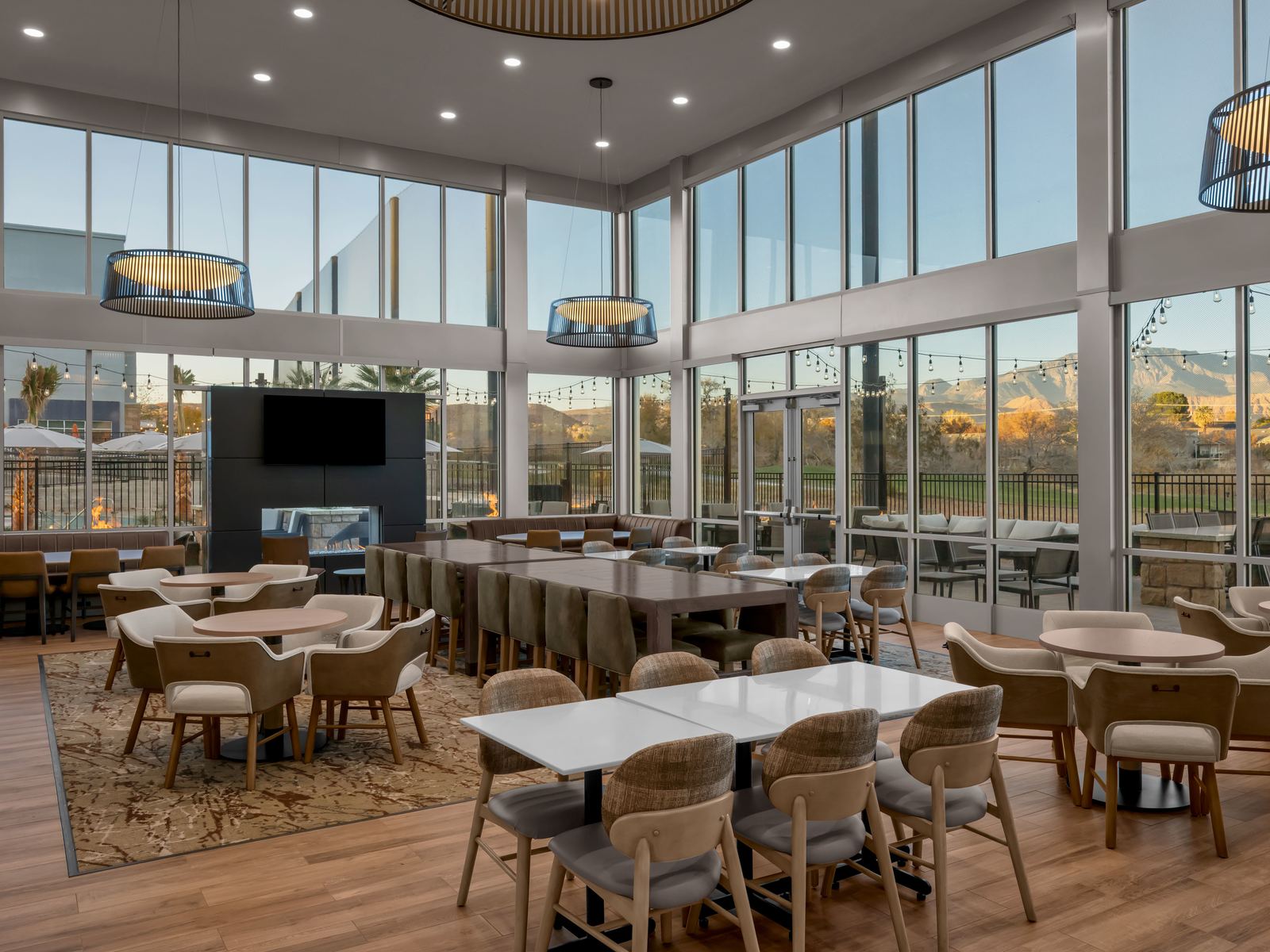The dining room at Back Nine Bistro & Bar, with floor-to-ceiling windows looking out on the golf course and the red rock beyond